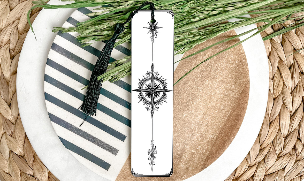 a white plate topped with a green plant and a bookmark