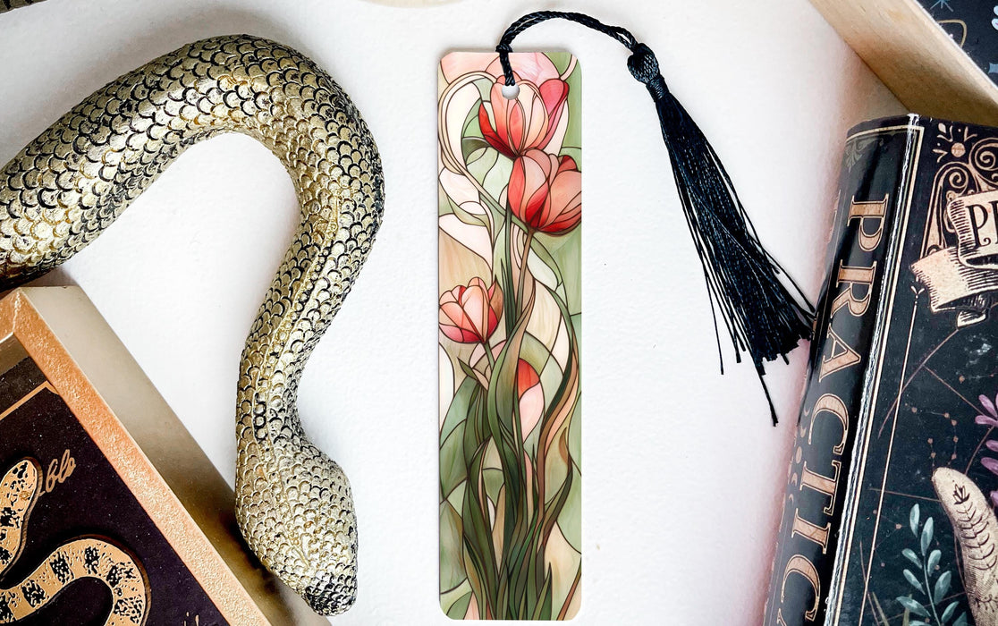 a snake, a bookmark, and some books on a table