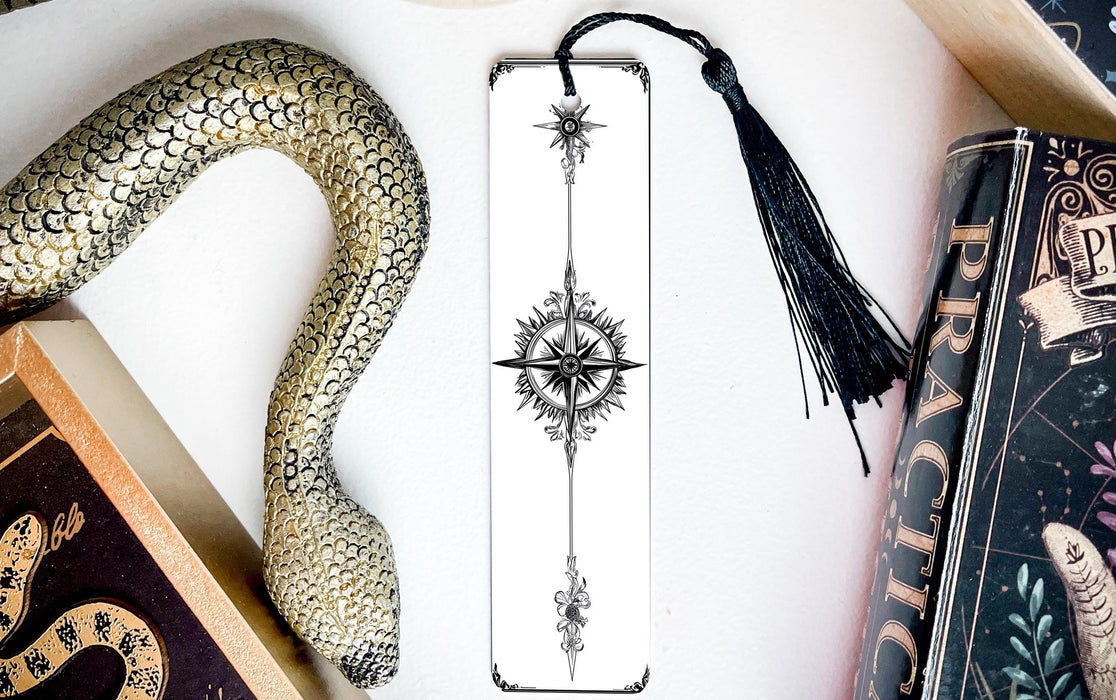 a snake, a bookmark, and some books on a table
