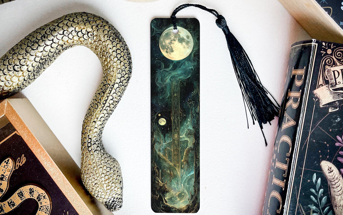 a bookmark with a snake and a moon on it