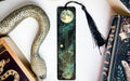 a bookmark with a snake and a moon on it