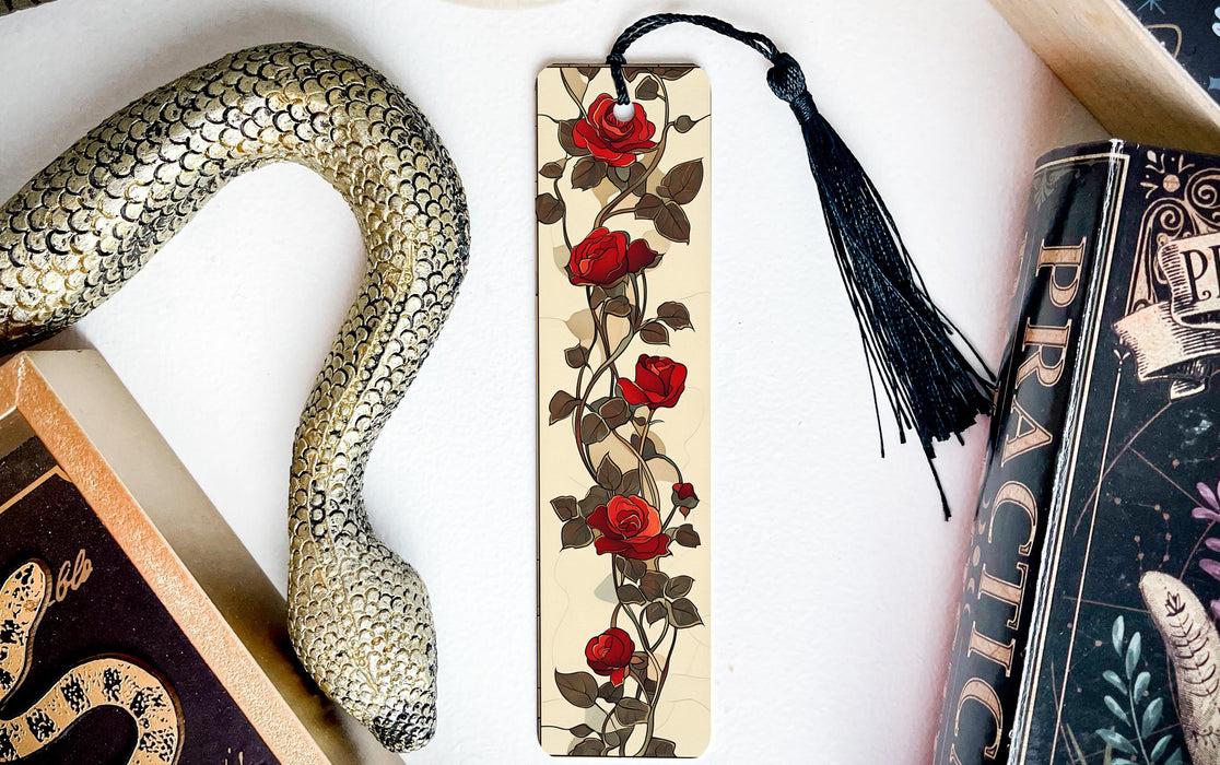 a bookmark with a snake and roses on it