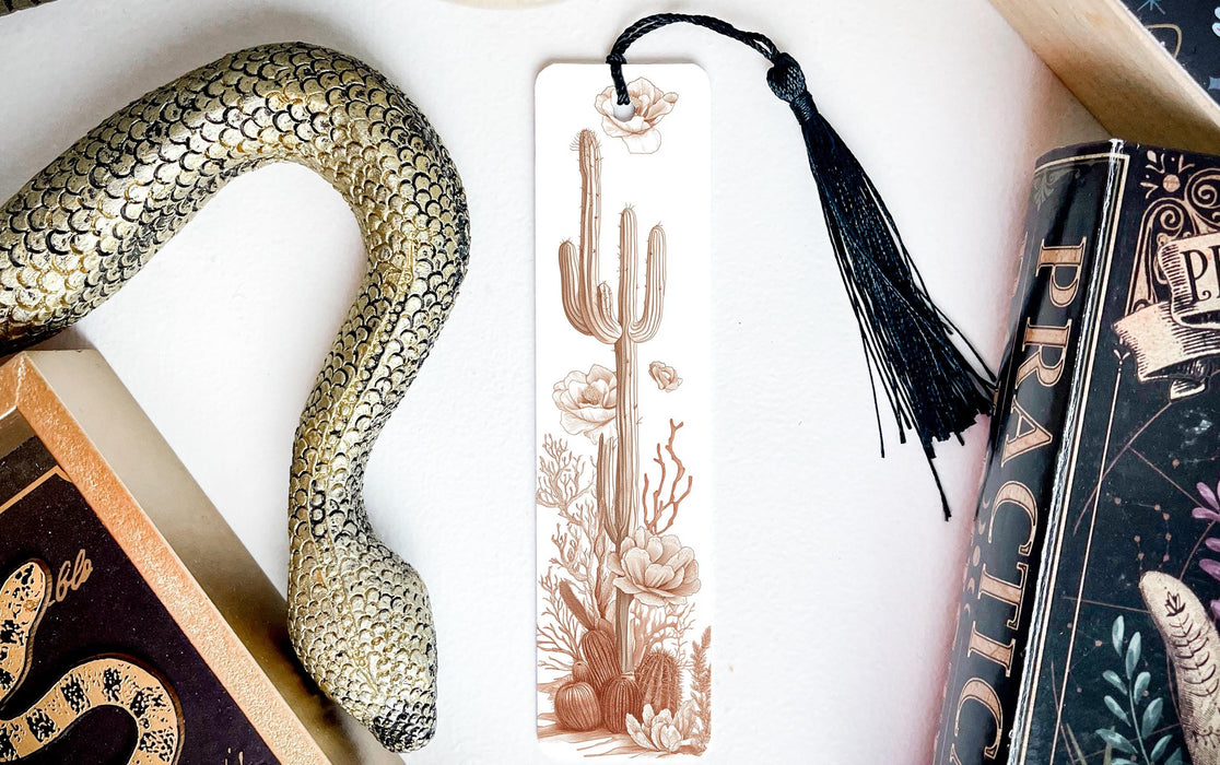 a bookmark with a snake on it next to a book