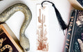 a bookmark with a snake on it next to a book