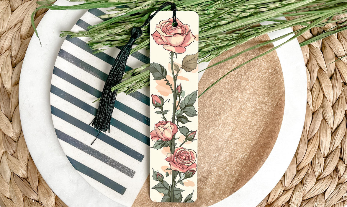 a bookmark with flowers on it sitting on a plate