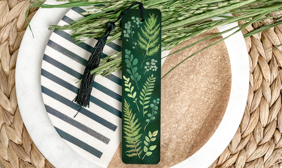 a green bookmark sitting on top of a white plate