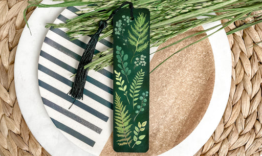a green bookmark sitting on top of a white plate