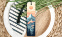 a bookmark with a mountain scene on it