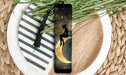 a bookmark with a silhouette of a woman sitting on a crescent