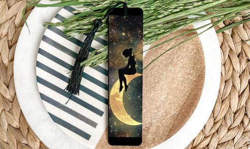 a bookmark with a silhouette of a woman sitting on a crescent