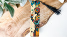 a piece of wood with a tassel hanging from it