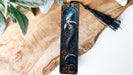 a wooden plaque with a mermaid on it