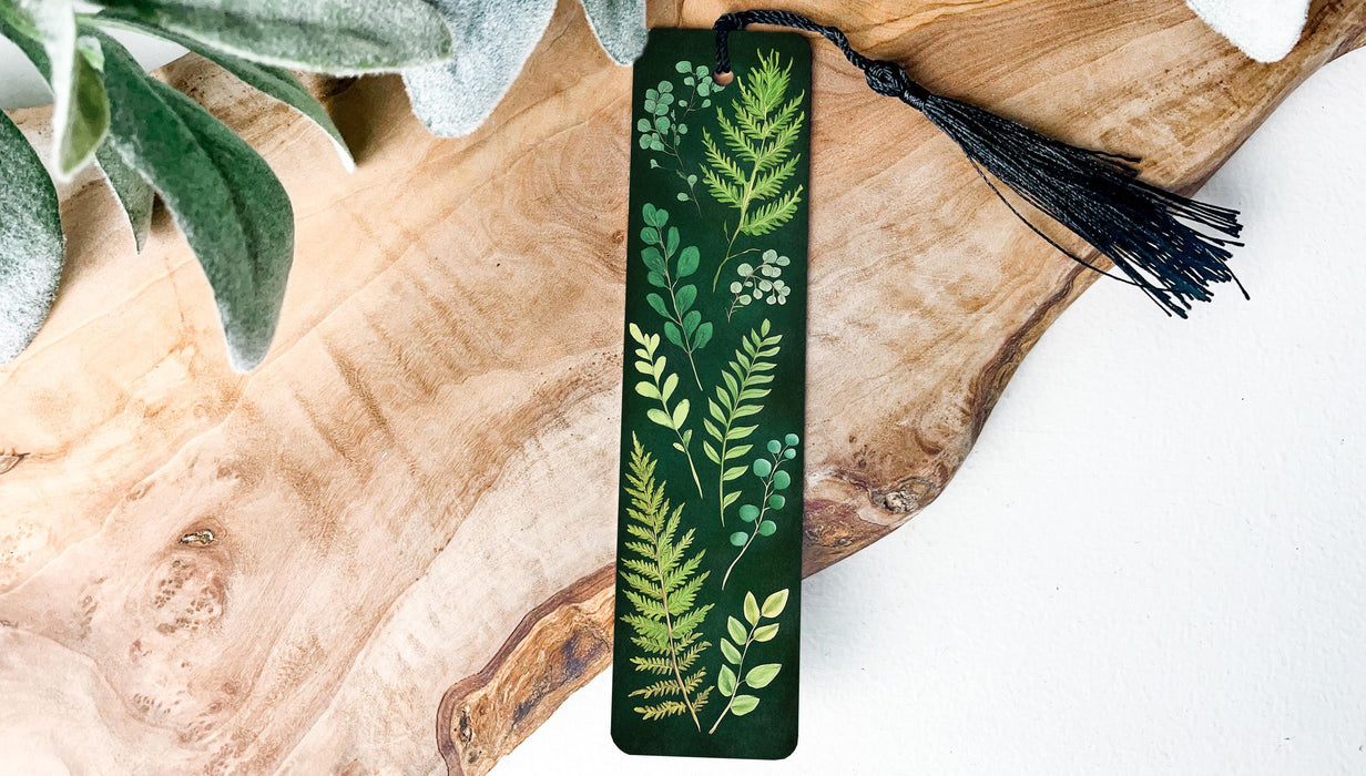 a green bookmark with leaves and berries on it