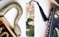 a bookmark with a snake and flowers on it
