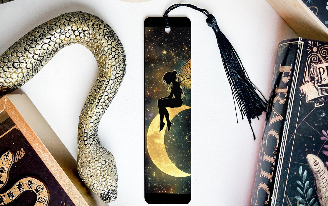 a bookmark with a fairy sitting on top of it