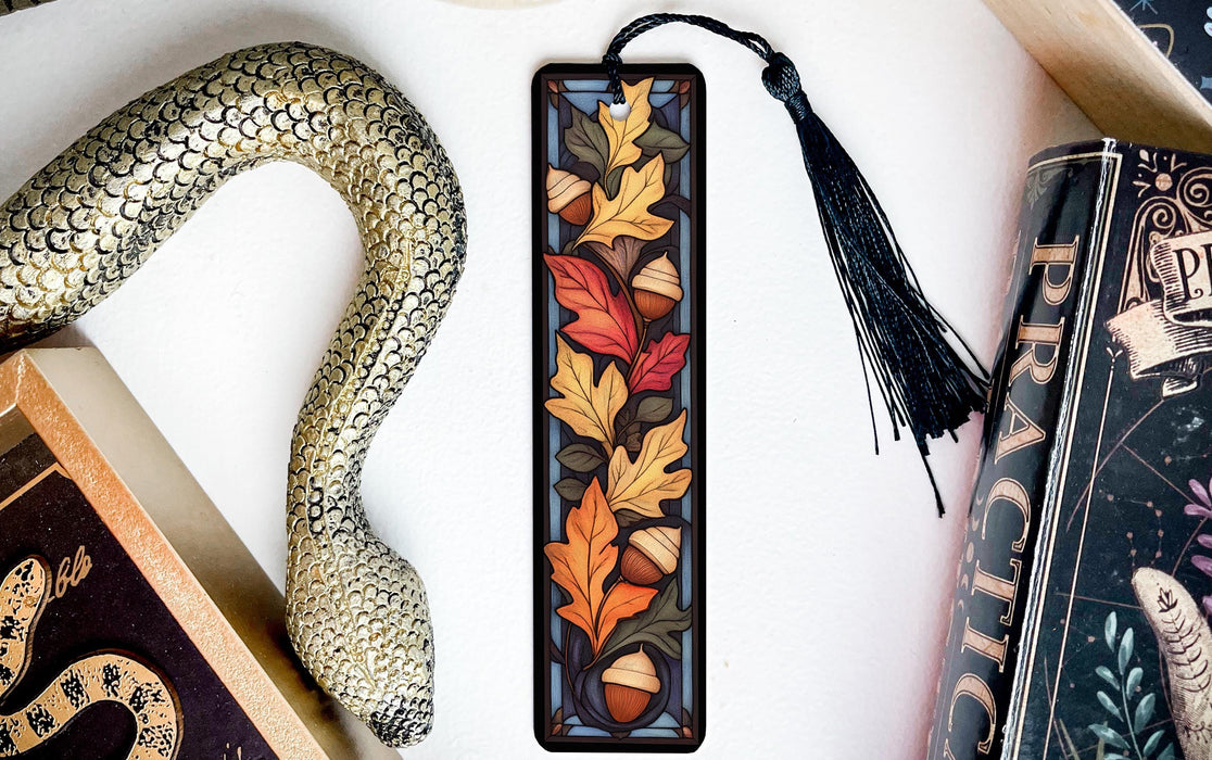 a snake, a bookmark, and some books on a table