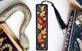 a snake, a bookmark, and some books on a table