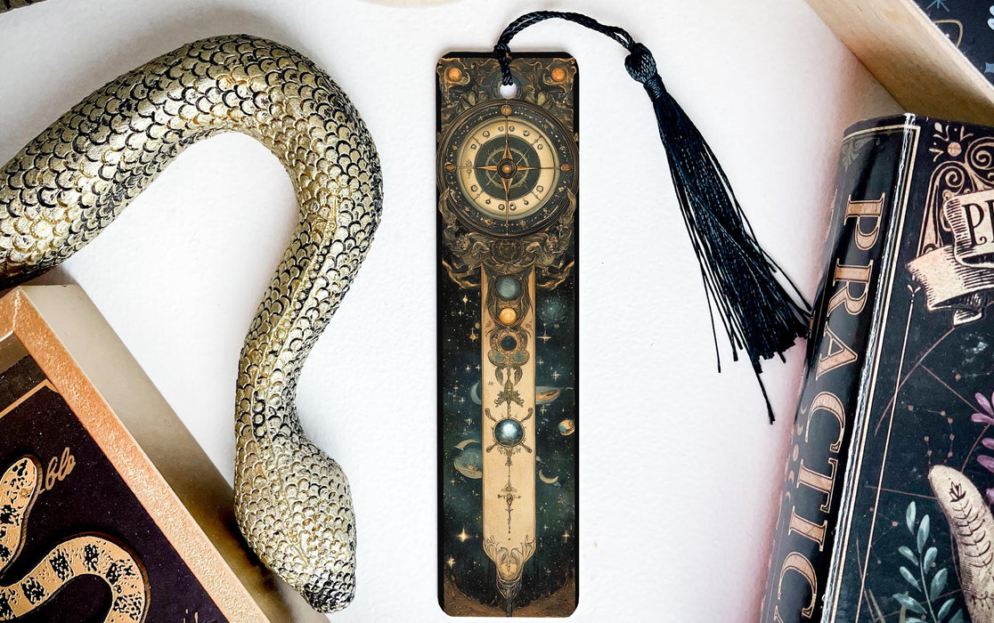a bookmark with a snake on it next to some books
