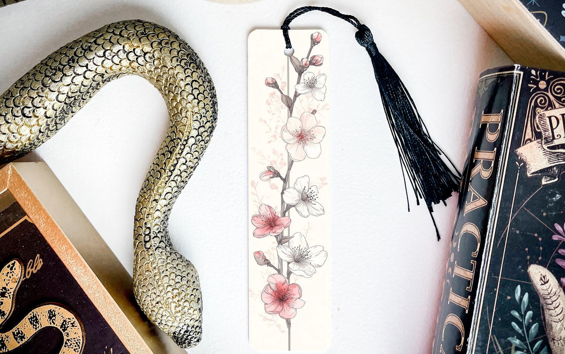 a bookmark with a snake and flowers on it