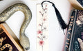 a bookmark with a snake and flowers on it