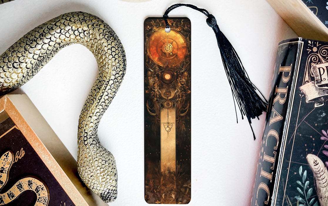a bookmark with a snake on it next to books