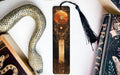 a bookmark with a snake on it next to books