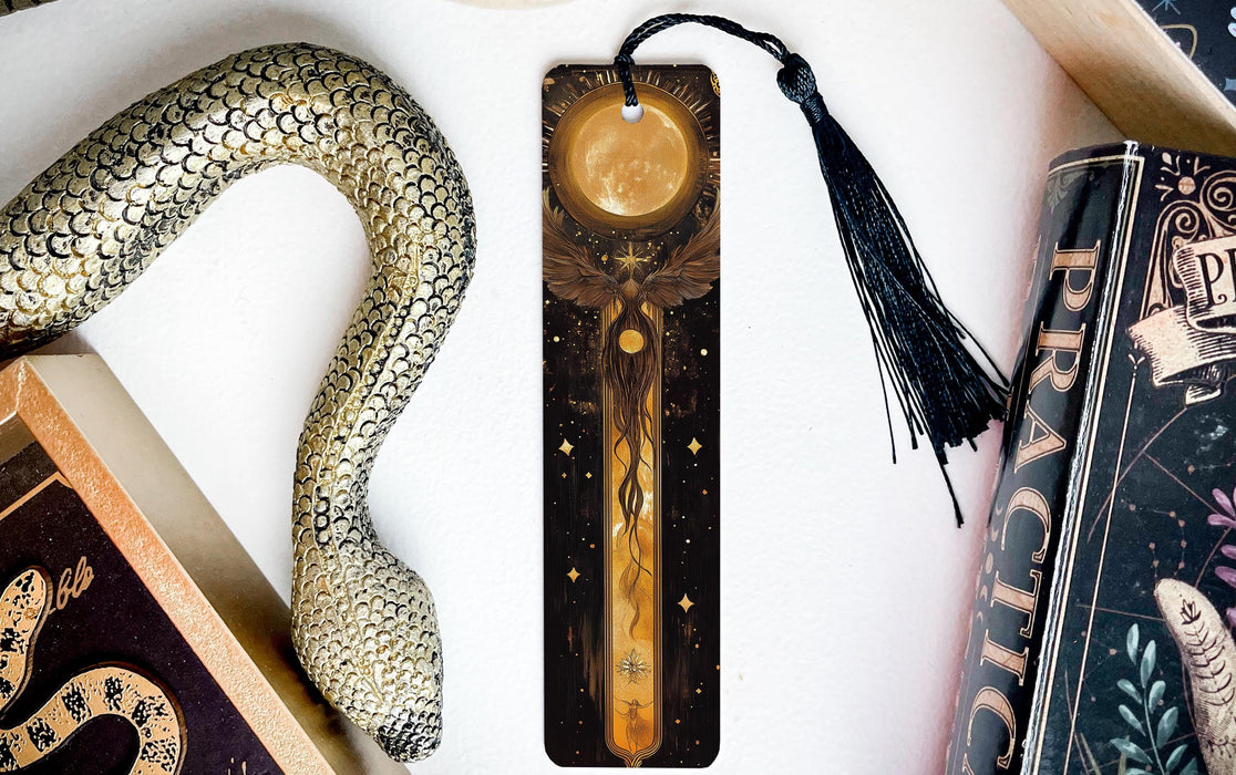 a bookmark with a snake on it next to books