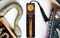 a bookmark with a snake on it next to books