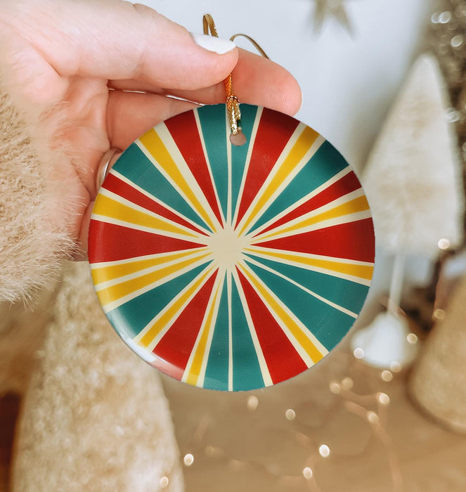 a person holding a christmas ornament in their hand