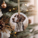 a brown and white dog ornament hanging from a christmas tree