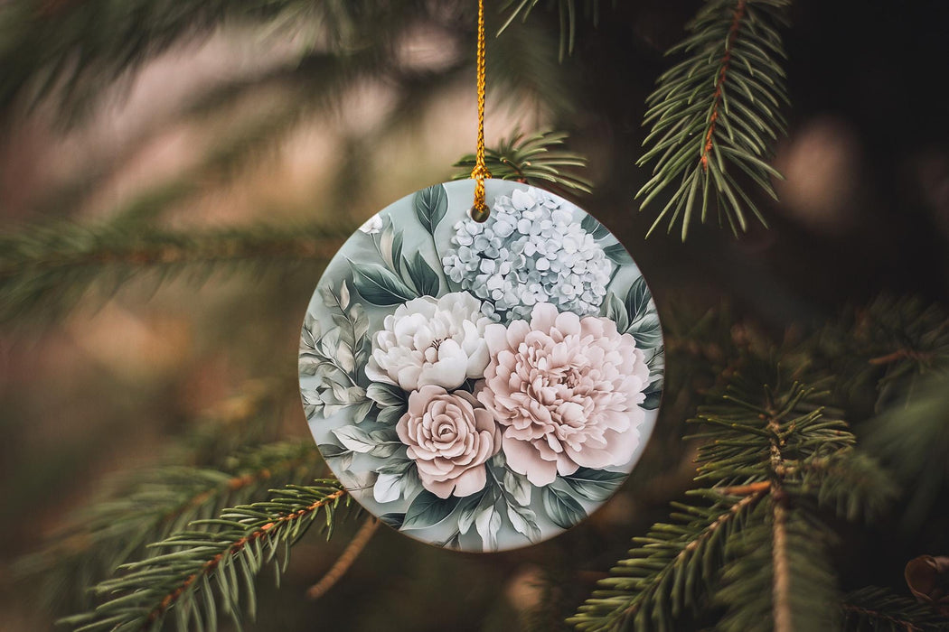 a glass ornament with flowers hanging from a tree