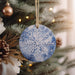 a snowflake ornament hanging from a christmas tree