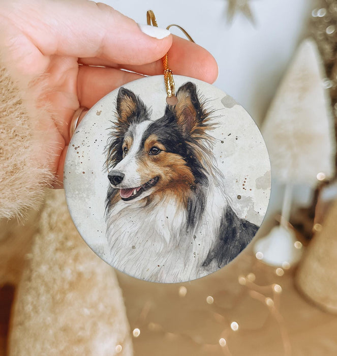a hand holding a small ornament with a picture of a dog on it