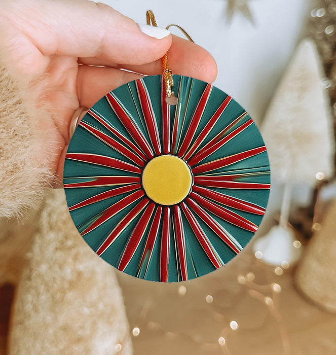 a person holding a christmas ornament in their hand