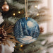 a christmas ornament hanging from a christmas tree