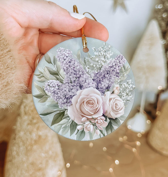 a person holding a round ornament with flowers on it