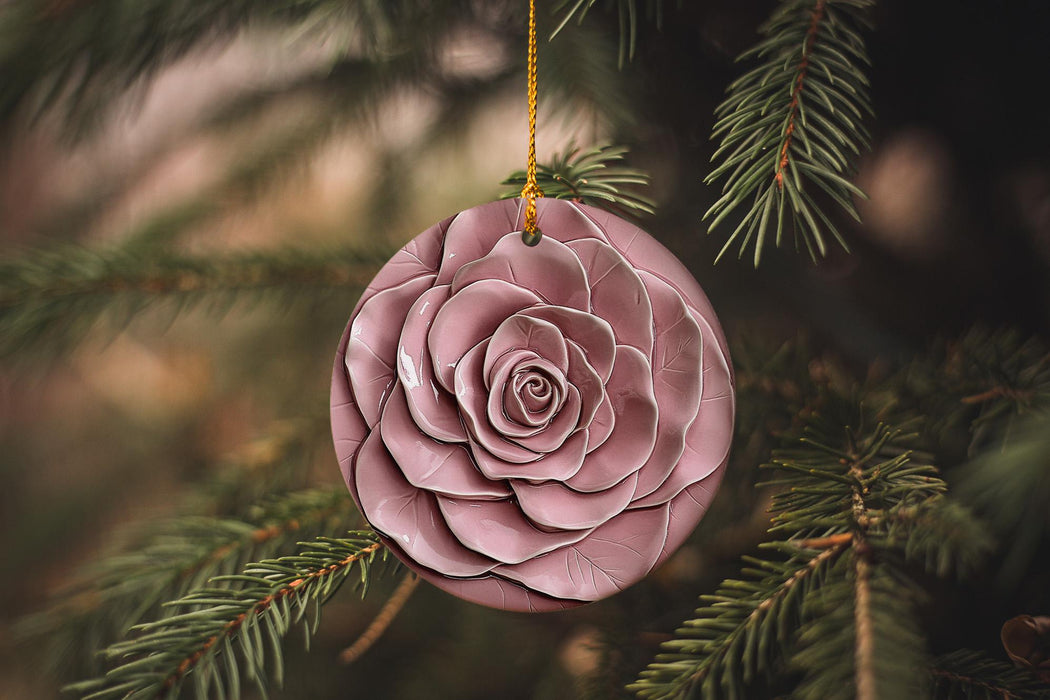 a pink ornament hanging from a pine tree