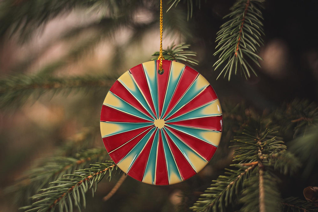 a colorful ornament hanging from a christmas tree