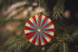 a colorful ornament hanging from a christmas tree
