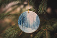 a ceramic ornament hanging from a christmas tree