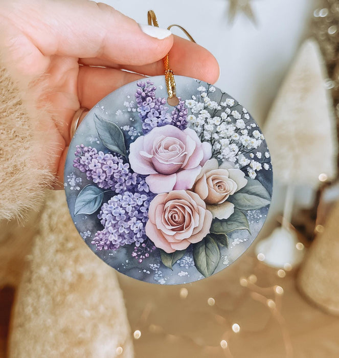 a person holding a round ornament with flowers on it