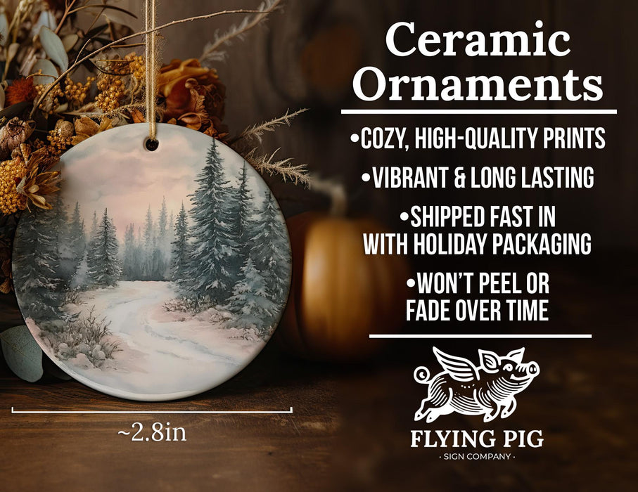 a ceramic ornament with a snowy forest scene