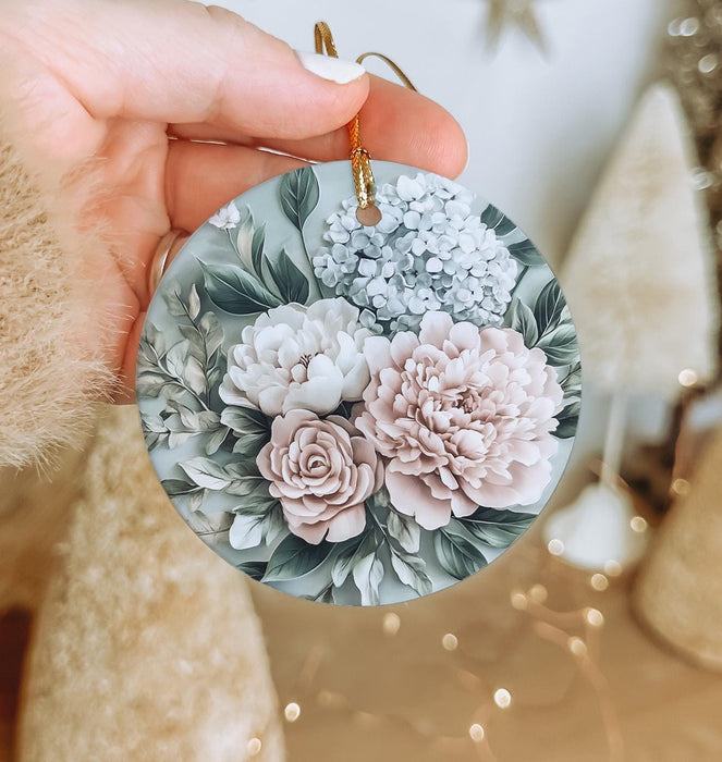 a person holding a flower ornament in their hand