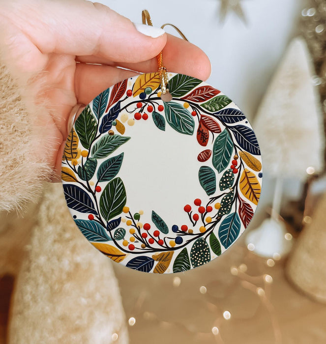 a person holding a christmas ornament in their hand