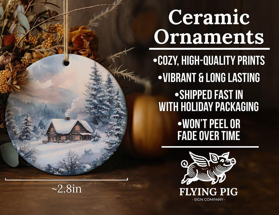 a ceramic ornament with a cabin in the woods