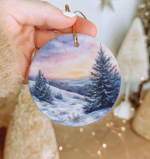 a person holding a christmas ornament in their hand