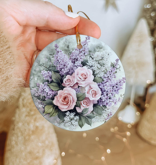 a person holding a round ornament with flowers on it