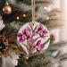 a ceramic ornament hanging from a christmas tree