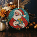 a christmas ornament with a santa clause holding a gift