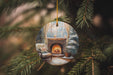 a christmas ornament hanging from a christmas tree